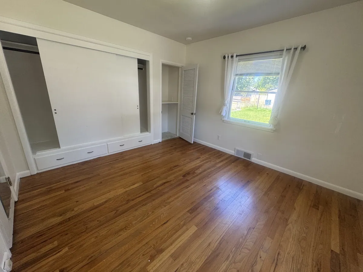 Finished bedroom with new trim, paint and flooring