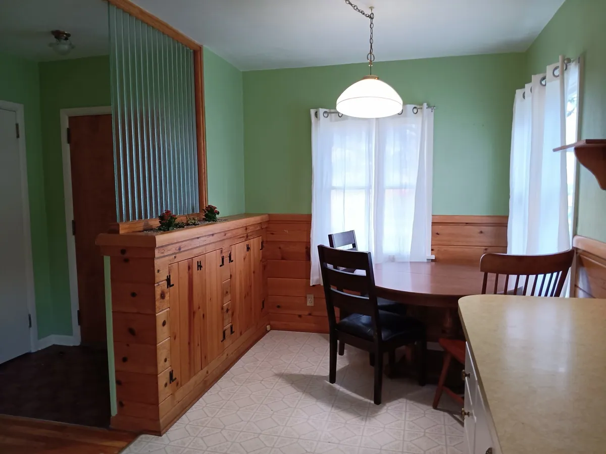 The same dining room before painting, with dated wall color and finishes