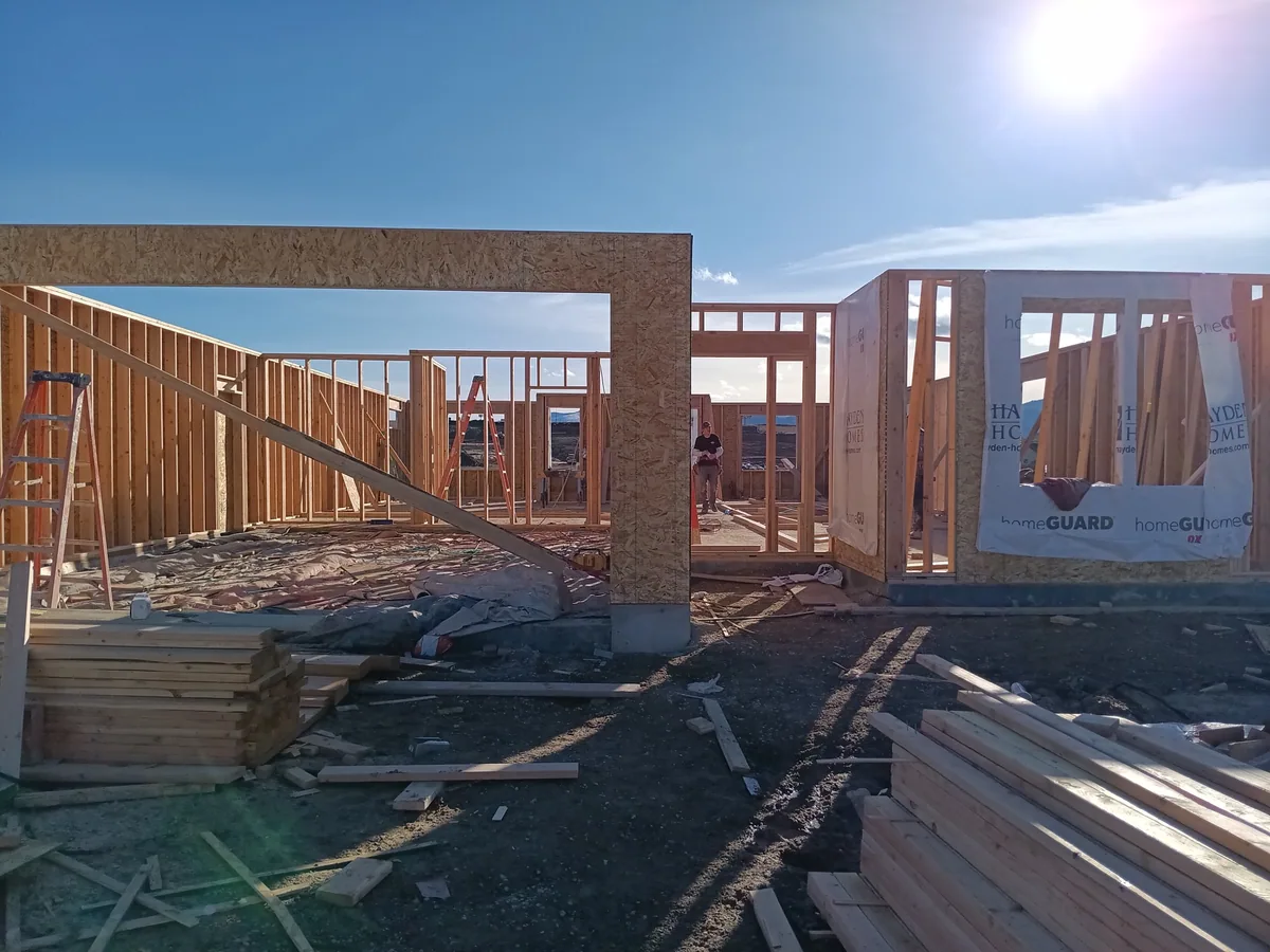 A large framed opening with a built-up header and floor joists on a new build