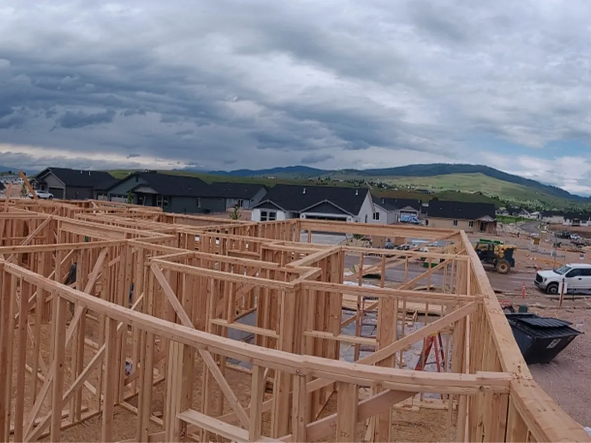 Several homes being framed at once across a subdivision site
