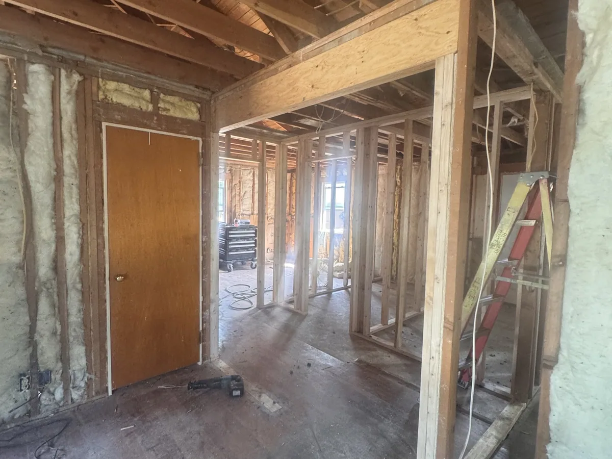 New stud walls and doorways framed inside a gut remodel
