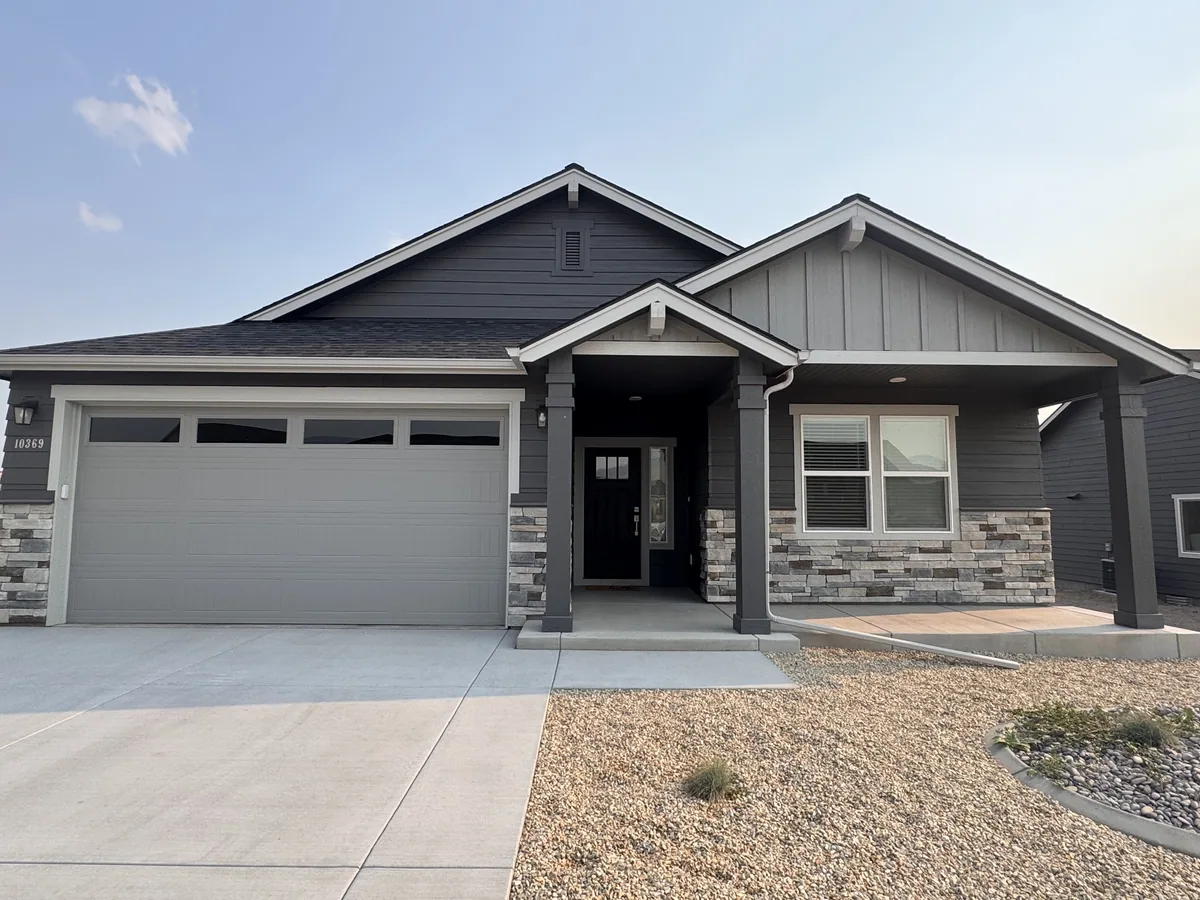 Finished craftsman-style home with stone wainscot and a two-car garage