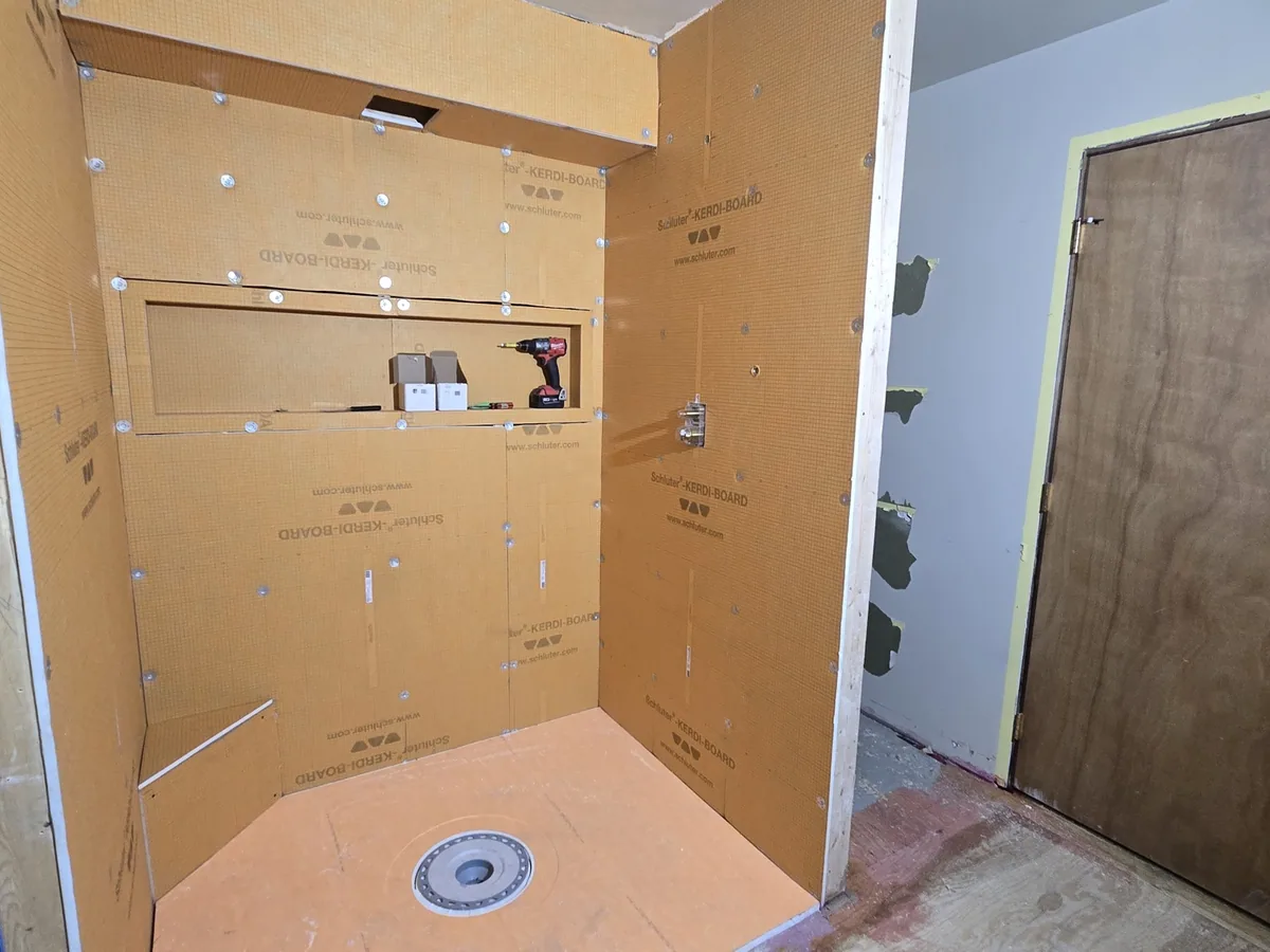 The same waterproofed shower alcove from a wider angle during the bathroom build
